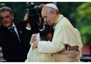 Il Papa abbraccia la piccola June che ha raccontato la sua testimonianza tra i bambini di strada